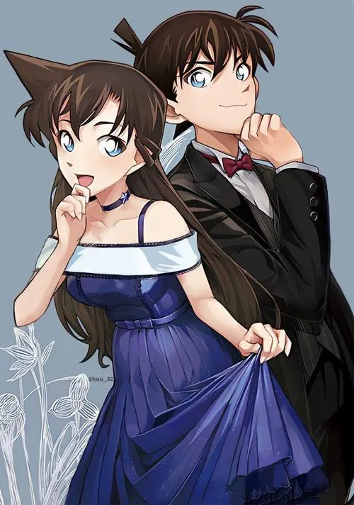 Ran váy xanh đậm, Shinichi đứng sau như chở che, bối cảnh đơn sắc làm nổi bật biểu cảm