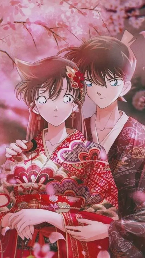 Shinichi và Ran giữa nền hoa anh đào, sắc hồng phủ nhẹ, cảm giác thanh mai trúc mã rất rõ