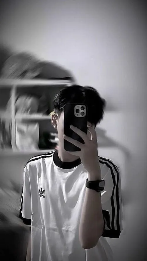 Vận động viên bóng rổ nam kéo cổ áo thi đấu che qua sống mũi, giọt mồ hôi đọng trên trán dưới ánh đèn thi đấu rực rỡ.